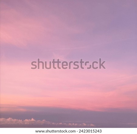 Blurred photo of dramatic pastel sunset sky. Purple and pink gradient colors. 