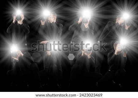 Group of photographers with cameras on black background. Paparazzi taking pictures with flashes