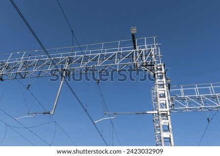 Electric contact line for the movement of electric locomotives. Equipment for the movement of electric locomotives. Wires for the power supply of electric locomotives on the railway. Royalty-Free Stock Photo #2423032909