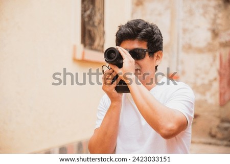  young latin man traveler photographer taking pictures in an ancient city