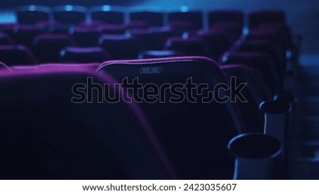 Immersive Cinematic Experience and Audience in Red Seats Enjoys Blank Wide Screen in Cinema Hall