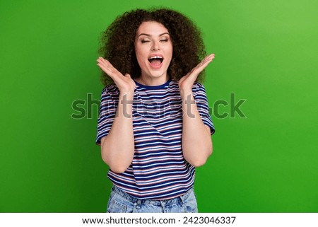 Photo of astonished overjoyed girl closed eyes open mouth raise arms palms applaud isolated on green color background