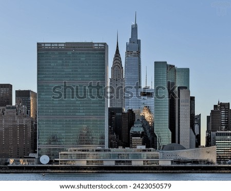 view of midtown manhattan skyline from long island city queens (un building, famous landmarks, tall skyscrapers) east side river (dusk, sunset, twilight) united nations