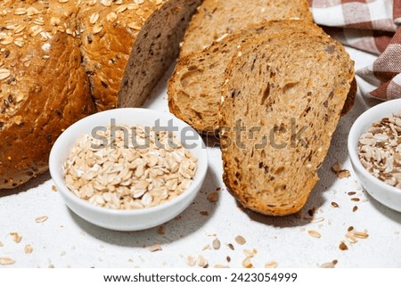 healthy bread with oats and seeds on white background, closeup horizontal