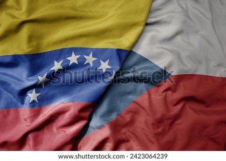 big waving national colorful flag of czech republic and national flag of venezuela . macro
