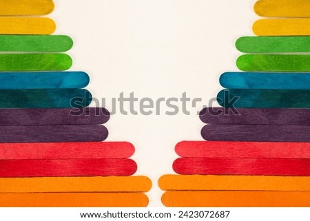 multi-colored sticks arranged in levels,colorful wooden sticks isolated on white background,Design of colorful background made up from ice cream stick,