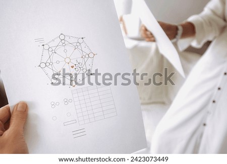 Calculation of the compatibility matrix between men and women in numerology, a woman holding a blank form in her hands Royalty-Free Stock Photo #2423073449