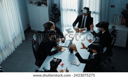 Top view of manager working on laptop and sending data analysis to business people by using VR glass headset while diverse team moving gesture while working together to planning idea. Directorate.