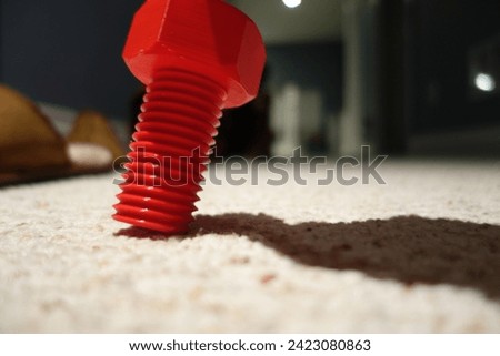 3d printed screw red blurry background floating