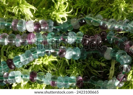 Natural fluorite on a background of green moss. Royalty-Free Stock Photo #2423100665
