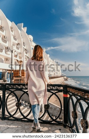 Woman summer travel sea. Happy tourist enjoy taking picture outdoors for memories. Carefree woman traveler posing on beach at sea on sunset, sharing travel adventure journey. Holiday vacation concept.