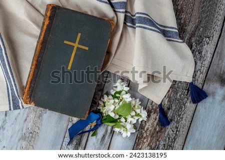 Old book Holy Bible. Cross on a dark cover. Sacred scripture, that contains the word of God. Ancient edition, vintage worn paper. Copy space Royalty-Free Stock Photo #2423138195
