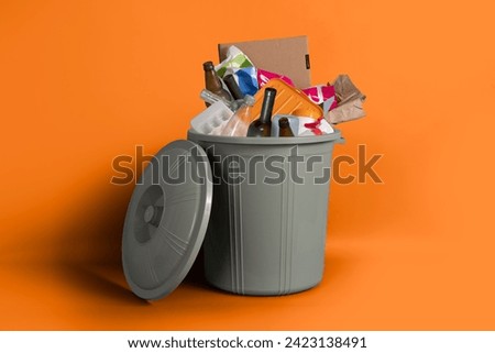 Trashcans, unsorted waste in plastic trash bins Royalty-Free Stock Photo #2423138491