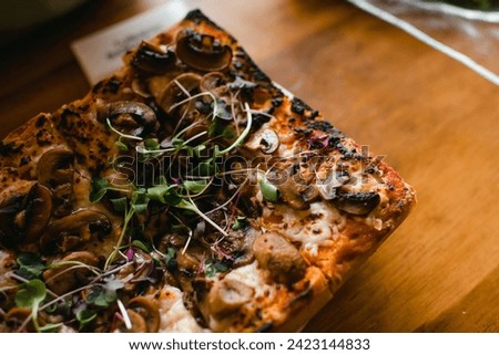 Cropped image of flatbread pizza with mushrooms and sprouts Royalty-Free Stock Photo #2423144833