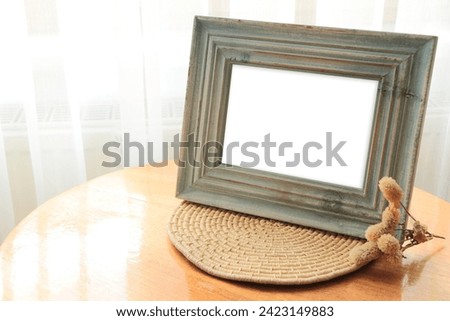 Blue color aged wood Desk photo frame. Empty horizontal picture frame mockup in minimalist interior.