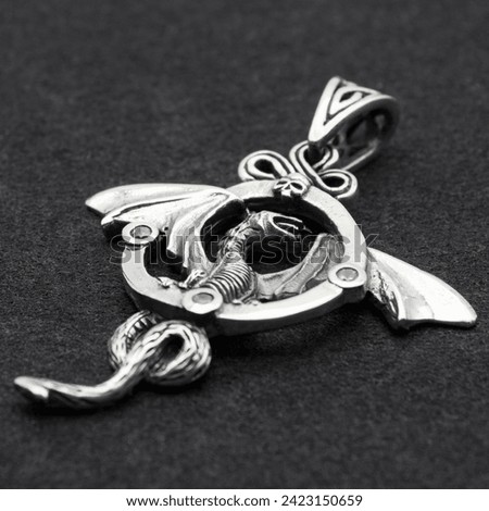 Silver dragon with wings pendant. 925 silver. Accessories for rockers, metalheads, punks, goths. Royalty-Free Stock Photo #2423150659