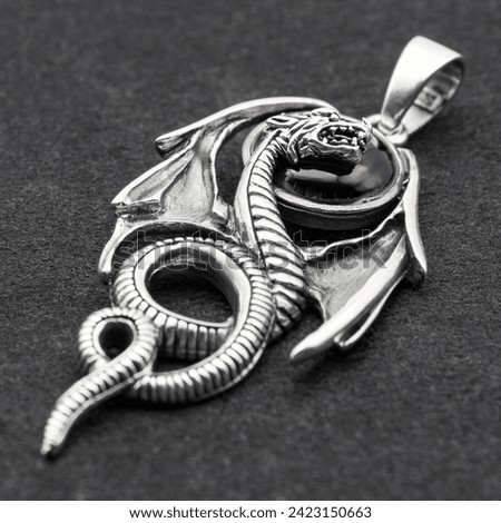 Silver dragon with wings pendant. 925 silver. Accessories for rockers, metalheads, punks, goths. Royalty-Free Stock Photo #2423150663