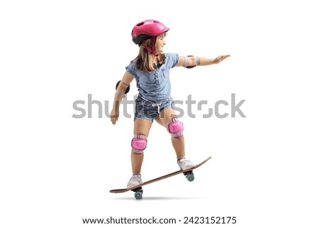 Little girl riding a skateboard with helmet, knee and elbow pads isolated on white background    
