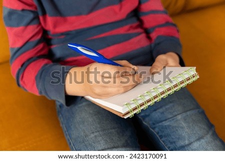 boy draws in a notebook. Homework. Development of creativity in a child.