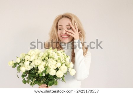 Beautiful pretty enjoying life healthy smiling modern lady with flowers. Party concept. 8 march concept. Women's day concept. Happy birthday concept. Celebrate day.