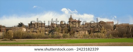 Typical Spanish inland village complete with church spire against a blue sky