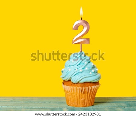 Birthday Cake With Candle Number 2 - On Yellow Background.