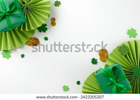 Shamrock shopping: unique finds for St. Paddy's Day. Top view photo of present boxes, folding fans, trefoils, coins, beads on white background with promo space