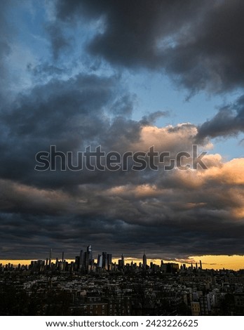 Vertical photo of powerful clouds above the New York City skyline Royalty-Free Stock Photo #2423226625