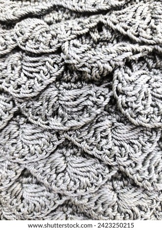 close-up photo of a handmade knit bag with a beautiful gray pattern