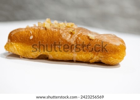 donut with fruit inside and sprinkles, bread, close-up view, on a light background, blurred background
