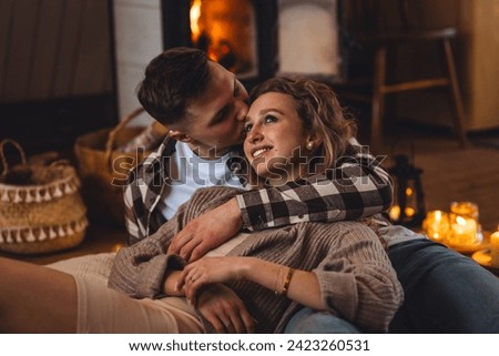 Romantic surprise for Saint Valentine's Day, christmas, new year. Weekend in the mountains in a countryside chalet house. Cozy atmosphere, relax. Candles, garlands, fireplace. Marriage proposal Royalty-Free Stock Photo #2423260531