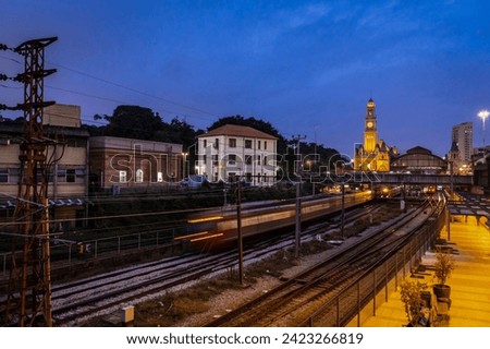 Facade of the historic building headquarters of Luz train Station and the Portuguese Language Museum, with the movement of trains in the maneuvering yard of CPTM, downtown Sao Paulo. Royalty-Free Stock Photo #2423266819