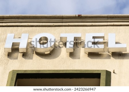 hotel advertisement with metal letters on the exterior facade, hotel advertisement concept