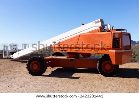 Telescopic Boom Lift For Construction, Painting, Electrical Work And Industrial Maintenance. Truck, Blue Sky On Background. Manlifting Cranes. Self Propelled Wheeled Hydraulic Articulated Boom Lift Royalty-Free Stock Photo #2423281441