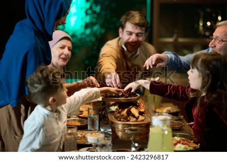In this modern portrayal, a European Islamic family partakes in the tradition of breaking their Ramadan fast with dates, symbolizing unity, cultural heritage, and spiritual observance during the holy Royalty-Free Stock Photo #2423296817