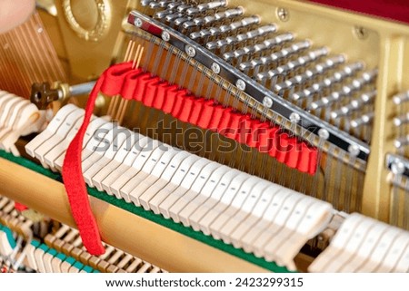 Shallow focus close-up of tools for tuning the internal mechanisms of an upright piano. Gives a feeling of luxury, classic, luxury, grandeur. Pictures can be used on various topics related to music.