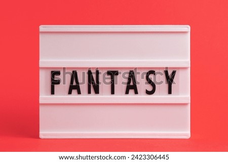The word fantasy on lightbox isolated red background. Literary Genres