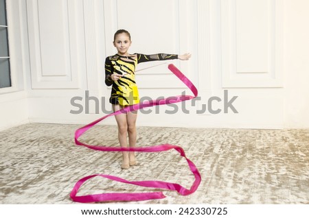 Sport training beautiful girl with Pink Rhythmic gymnastics ribbon in white room jumping and doing professional exercises 