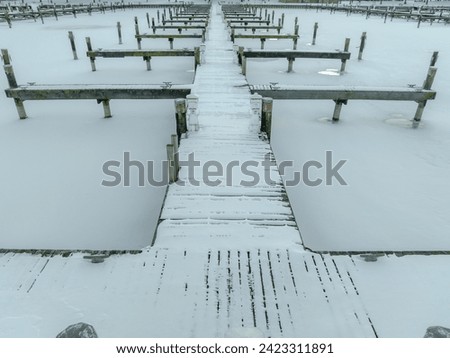 Winter aerial photo of frozen, snowy marina, docks at Allan H Treman State Marine Park, Ithaca, NY, USA. 01-21-2024	