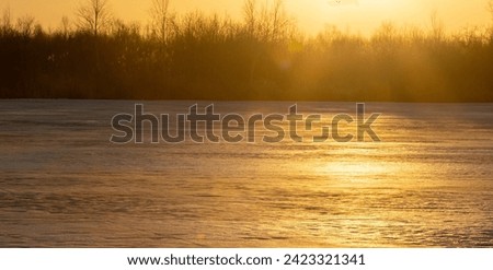 North-eastern European river after frosty winter. Porous ice began to melt, river is swollen, state of ice week before ice break (ice-boom). Aurora, sunrise colors on a spring moning Royalty-Free Stock Photo #2423321341