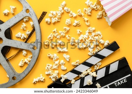 Camena concept with film reels and popcorn. Movie background.