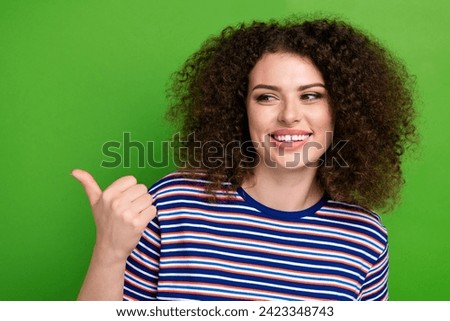 Portrait of lovely lady toothy smile look direct thumb finger empty space offer isolated on green color background