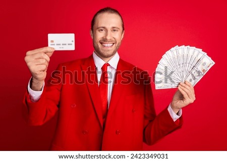 Photo portrait of handsome young guy hold credit card money fan dressed stylish classic outfit isolated on red color background