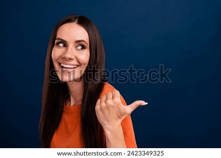 Portrait of adorable person with long hair wear stylish clothes look directing at sale empty space isolated on dark blue background