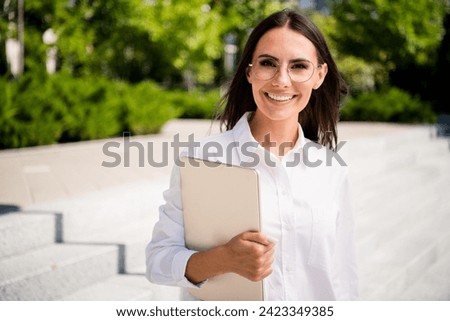 Photo of cheerful lovely woman dressed stylish shirt glasses going office work spring sunlight