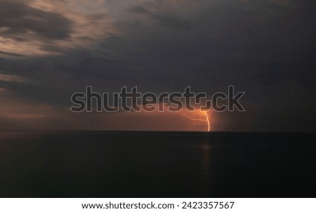 Lightning over the sea during a thunderstorm on a summer night