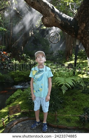Beautiful boy, look of fashion child, outfit of cute kid in Chom Cafe in Chiang Mai, Thailand. Thai nature, landmark. Wild scenery Royalty-Free Stock Photo #2423374885