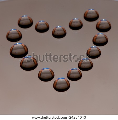Water drops in the form of heart on a celebratory background