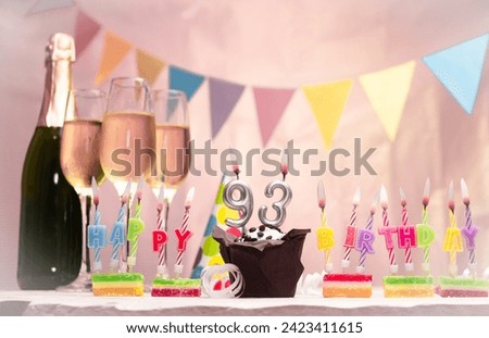 Birthday with champagne and glasses. Birthday candle with number 93. Anniversary card with garlands save space. Festive background. Royalty-Free Stock Photo #2423411615