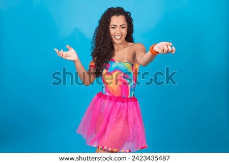 Closeup of beautiful woman dressed for carnival night pointing to the sides free for text or mockup